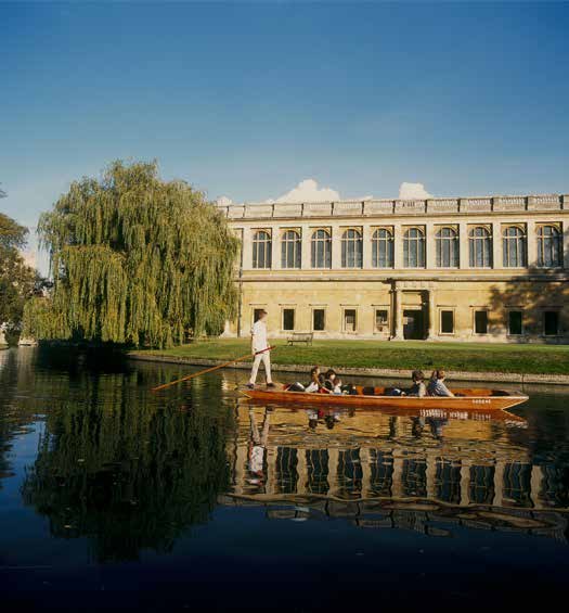Punting on the river in front of a Cambridge college
